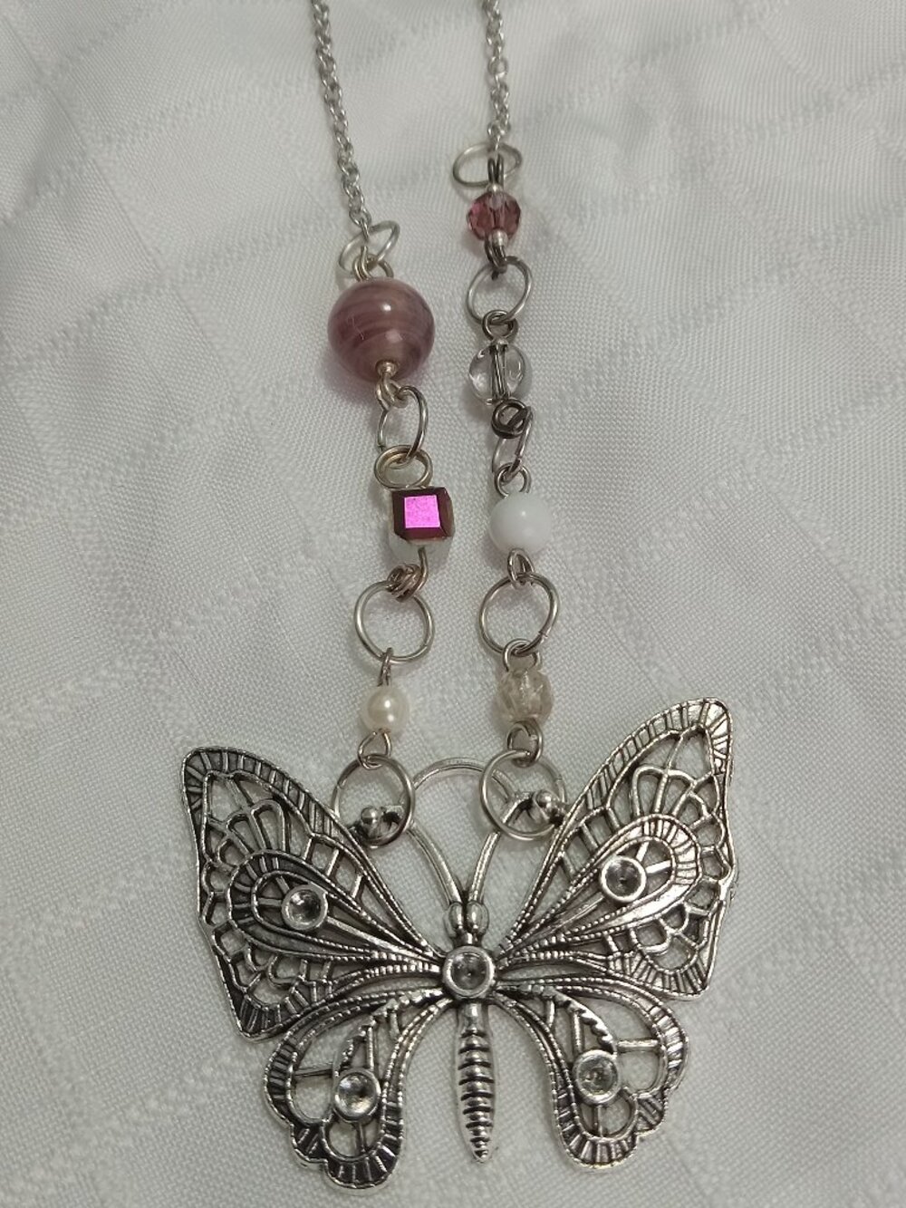 A pretty, minimalist, asymmetrical, reversible handmade necklace